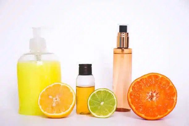 Natural cosmetics based on citrus oils. A bottle of shampoo, lotion and essential oil of OS lime, pieces of fresh fruit. Citrus scent.
